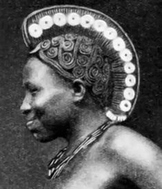 an old photo of a man wearing a headdress