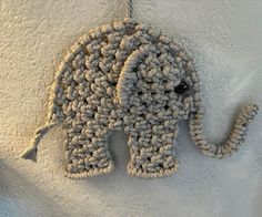 an elephant made out of crochet is hanging on the wall