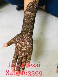 the hand is decorated with henna designs