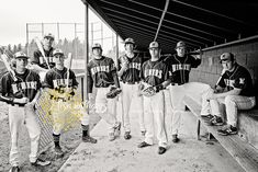 a group of baseball players standing next to each other in front of a dugout