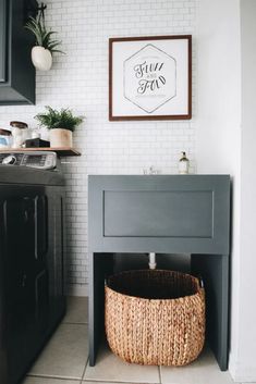 a laundry room with a sink, washer and dryer next to a basket on the floor