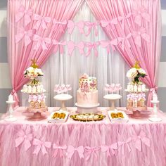 a table with pink and white desserts on it