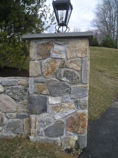 a light on top of a stone wall