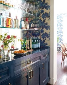 the kitchen is decorated with blue and white wallpaper