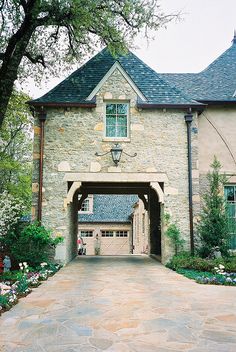 a large stone house with an arched entrance