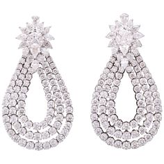 These earrings are a WOW!! Three rows of round diamonds set in a tear drop shape suspended from a fabulous cluster top. 15.60 carats of round, pear and marquise cut diamonds set in 18k white gold. Approximately 2 inches in length, approximately 1.20 inches at its widest point. A unique earring to add to any collection! Expensive Earrings, Unique Earring, Vintage Drop Earrings, Round Diamond Setting, Marquise Cut Diamond, Expensive Jewelry, Diamond Drops, Antique Earrings, Rough Diamond