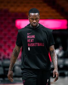 the miami heat basketball player is walking on the court with his hands in his pockets