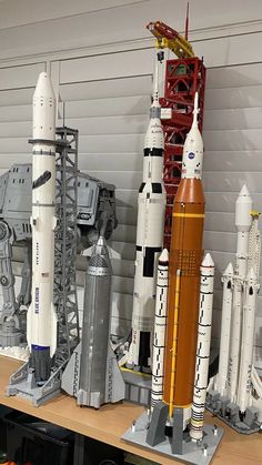 several model rockets on display in a room