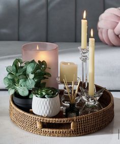 candles are arranged on a wicker tray