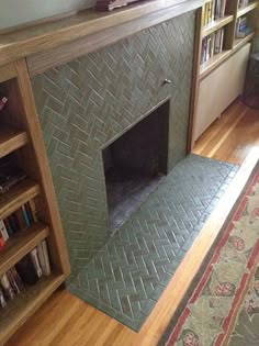 a living room with a fireplace and bookshelf