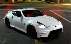 a white sports car parked in a parking lot