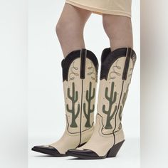 Knee High Cowboy Boots With Embroidery And Cactus Design. Contrast Toe Box And Collar. Side Pull Tabs. Pointed Toe. Heel Height: 2.8 Inches (7 Cm) Airfit. Flexible Technical Sole Made Of Latex Foam Designed To Offer Increased Comfort. Color: White/Ivory And Green Upper :100% Polyurethane Lining : 65% Polyester, 35% Polyurethane Sole: 100% Sbs Insole: 100% Polyester Excellent Condition. Almost Brand New. No Stains, Tears, Or Any Other Damage. White Summer Boots For Rodeo, White Boots For Summer Rodeo, White Summer Rodeo Boots, Summer Western Closed Toe Boots, Zara Cream Boots For Spring, Zara Casual Cream Boots, Casual Cream Zara Boots, White Casual Boots By Zara, Zara White Casual Boots