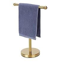 a blue towel is hanging on a gold stand with two towels in the middle and one folded