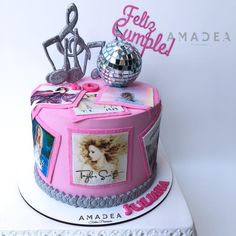 a birthday cake decorated with music and pictures