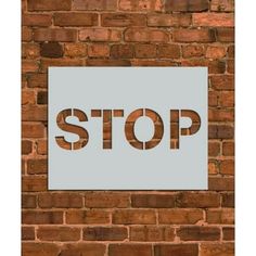 a sign on a brick wall that says stop