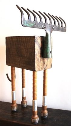 three wooden pegs are attached to the handle of a tool holder on top of a table