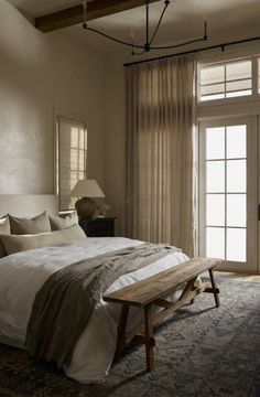 a bedroom with a large bed sitting next to a sliding glass door