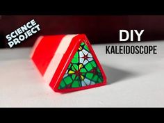 a red and white object sitting on top of a table next to the words science project diy kaleidoscope