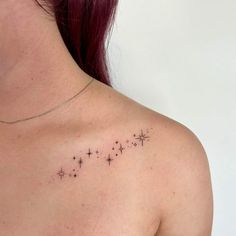 the back of a woman's shoulder with stars tattoo on her left arm and chest