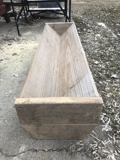 a wooden bench sitting on top of a dirt field