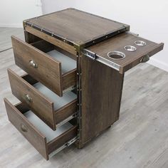 a wooden cabinet with three drawers on it