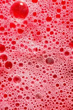 red bubbles in water on a pink surface