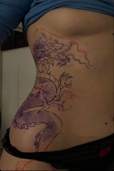 a woman with a dragon tattoo on her stomach