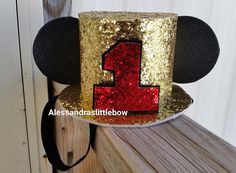 a mickey mouse hat with the number one on it