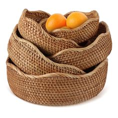 three wicker baskets stacked on top of each other with oranges in the middle