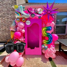 a pink box with balloons and sunglasses on it