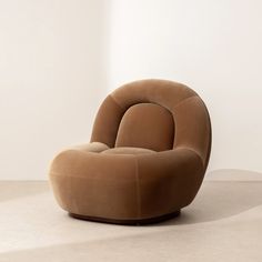 a brown chair sitting on top of a white floor