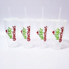 three plastic cups with straws in them sitting next to each other on a white surface