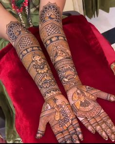 two hands with henna designs on them