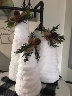 three white towels with pine cones on them