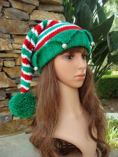 a mannequin head wearing a green and red knitted hat