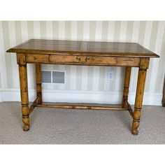 an old wooden table with two drawers on each side and one drawer at the top