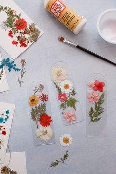 some flowers are sitting on the table next to glue