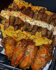 a tray filled with meat and other food items