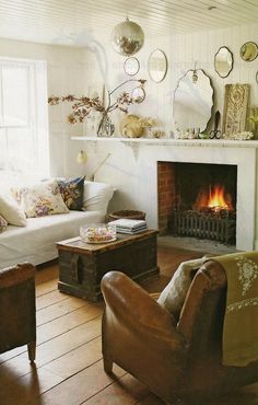 a living room filled with furniture and a fire place