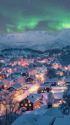 the aurora lights shine brightly over a snowy town