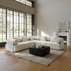 a large white couch sitting on top of a hard wood floored living room area