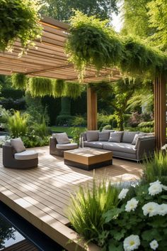 an outdoor living area with couches, tables and flowers on the deck in the foreground