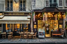 the outside of a restaurant with tables and chairs