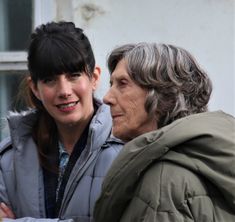 two women are standing next to each other