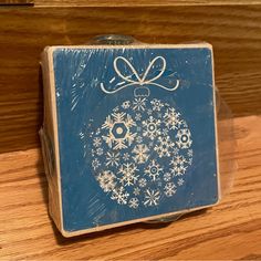 a blue box with snowflakes and a bow on it