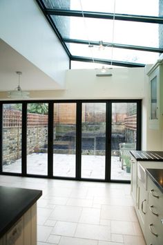 an empty kitchen with glass doors leading to the outside