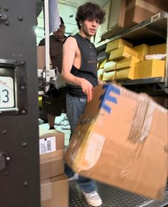 a man is moving boxes in the back of a truck