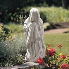 a statue of a woman standing in a garden