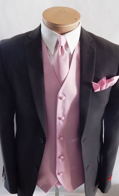 a black suit with pink shirt and tie