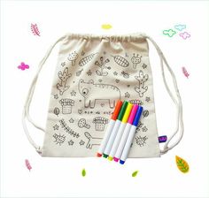 four colored pencils in a drawstring bag on a white background with colorful drawings